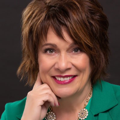 Stacy Nimmo headshot in front of dark background